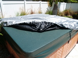 Pulling the spa cap over the corners of the hot tub cover